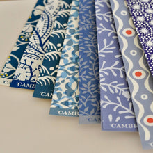 Load image into Gallery viewer, Collection of blue and white patterned fabric swatches with 'Came' branding.
