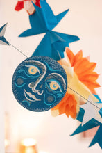 Load image into Gallery viewer, Decorative paper cutout with star and moon design on a blurred background