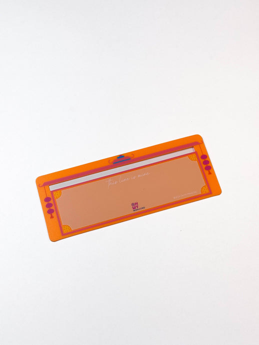 Rectangular orange tool with a white center on a light gray background