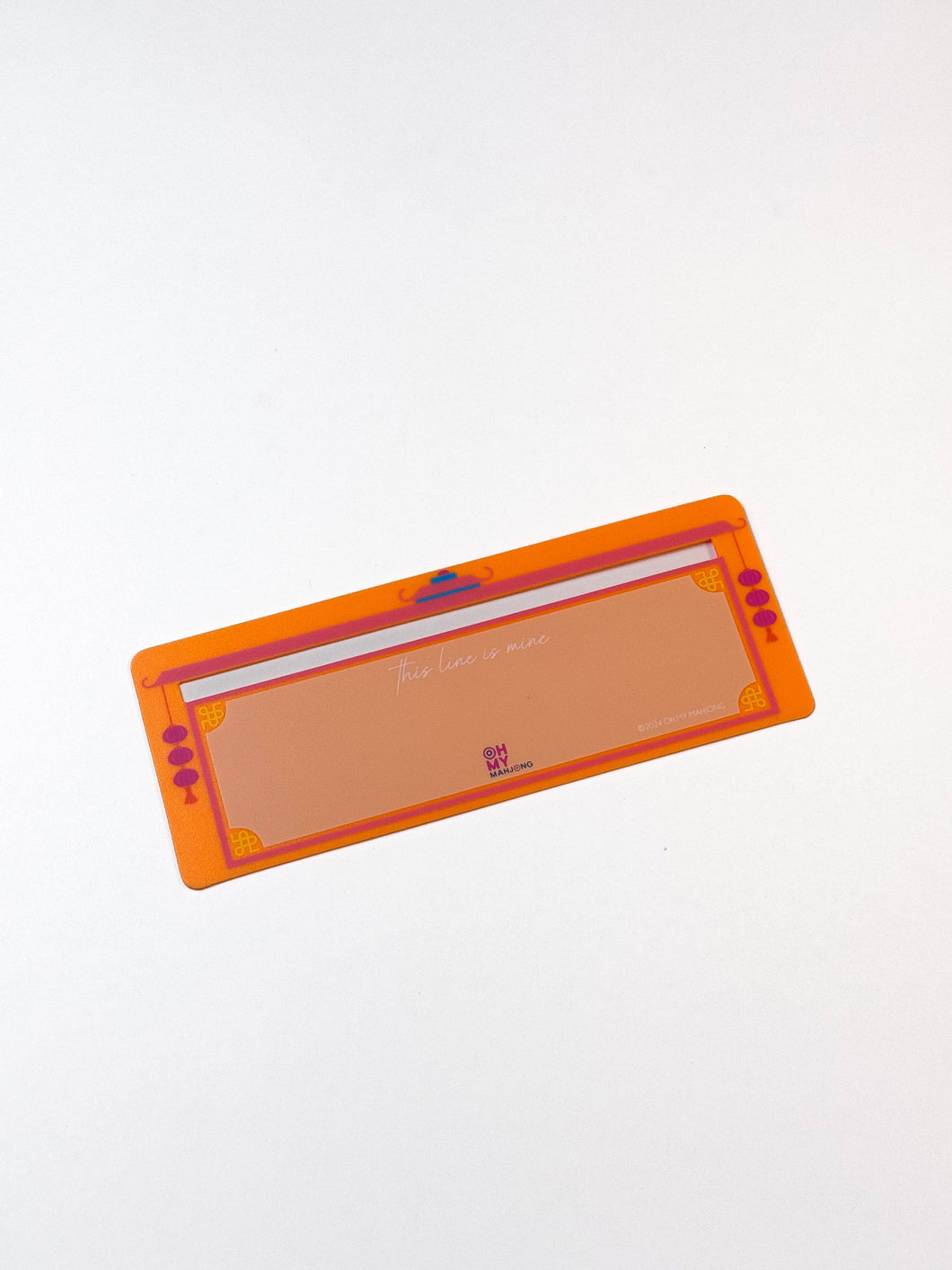 Rectangular orange tool with a white center on a light gray background