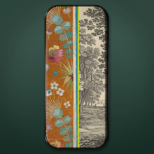 Load image into Gallery viewer, Long colorful tray on green background. Tray features images of flowers and trees in shades of orange, green, blue, pink, and gray