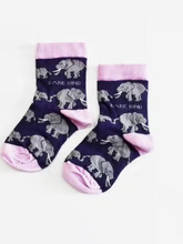 Load image into Gallery viewer, Dark purple socks with light lavender cuffs, heels and toes. Grey elephants with white tusks line the socks. The name Bare Kind is written in light grey under the first row of elephants.