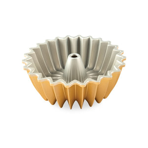 Bundt pan flipped upside down to show light gray inside; gold outside showing from front; pictured on white background