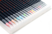 Load image into Gallery viewer, Close up of tips of watercolor brush pens in all colors of rainbow. Main body of pens shown to be black with orange lettering on the side. Tips of pens covered with small clear plastic caps