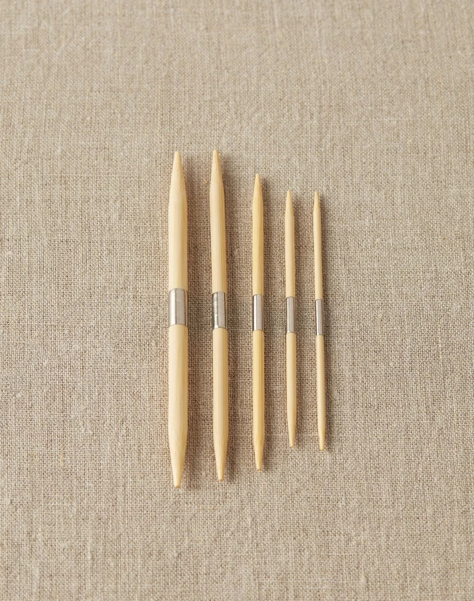 Bamboo cable needles with nickle-plated steel band in the center to use on a magnetic surface to keep them in reach.