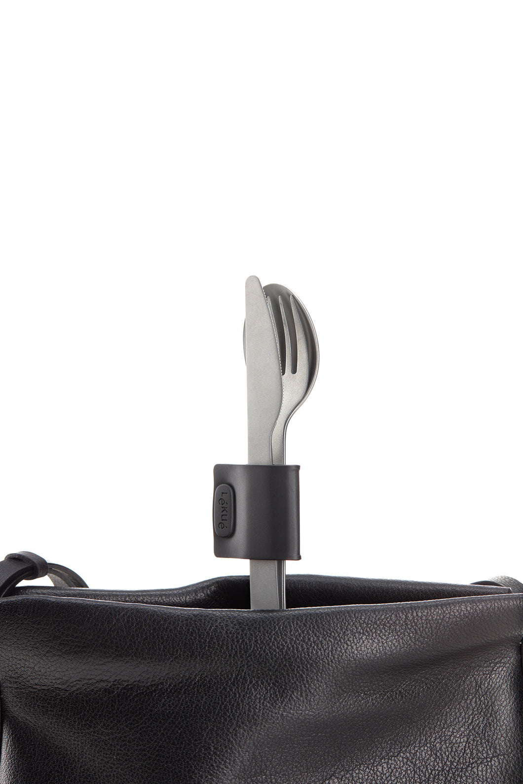 Set of silverware; knife, fork and spoon. The three utensils are held together by a black clasp as they sit standing upright in a black bag.