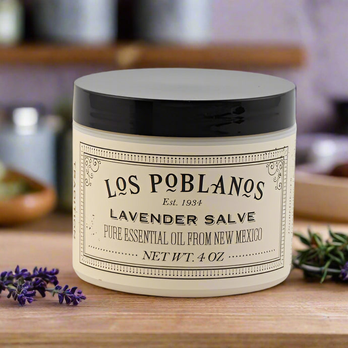 A jar of Los Poblanos Lavender Salve with a black lid and a label that includes the name of the product and 'Pure Essential Oil from New Mexico'. The salve is multipurpose and all-natural.